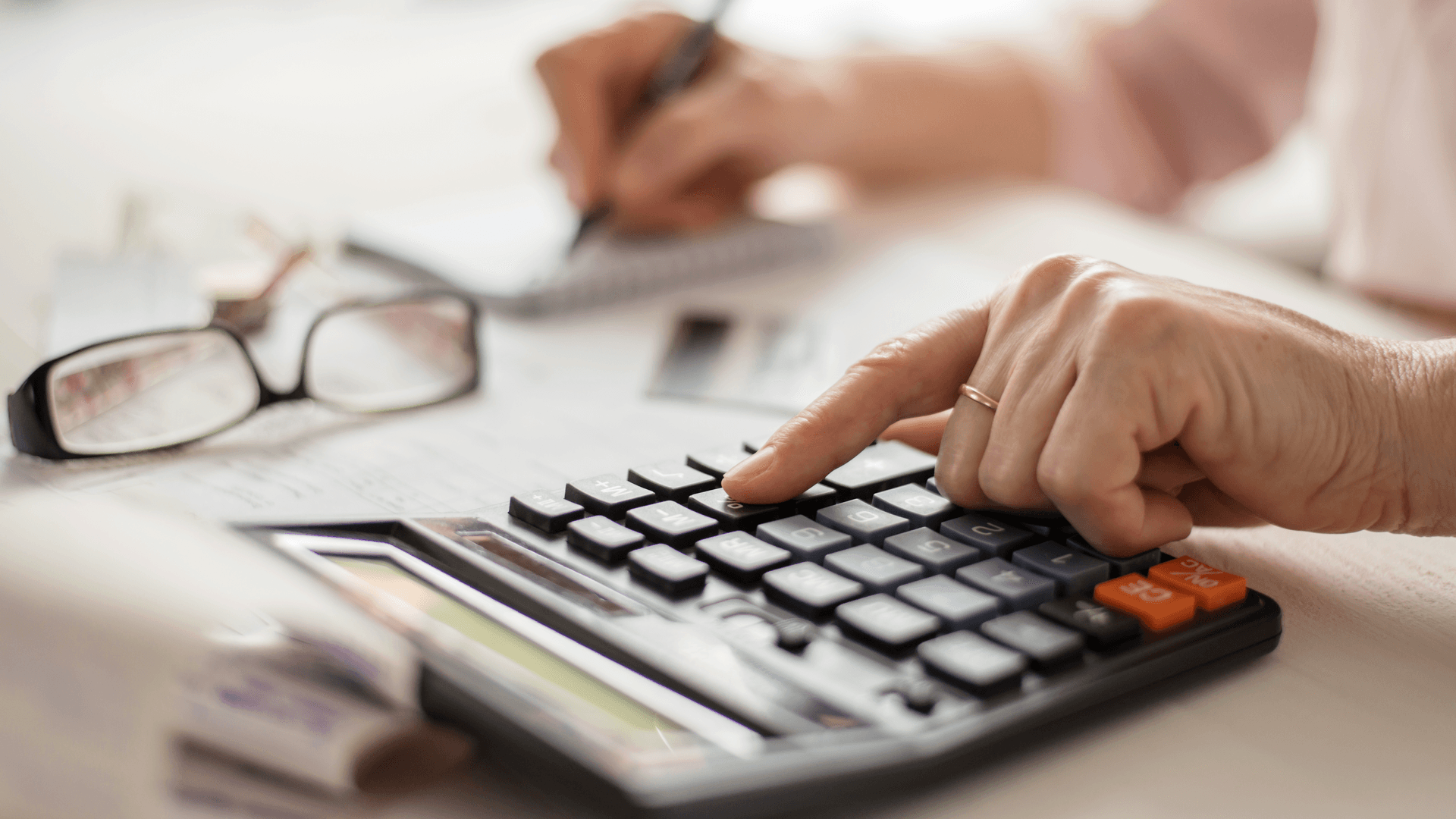 A close-up of a person using a calculator