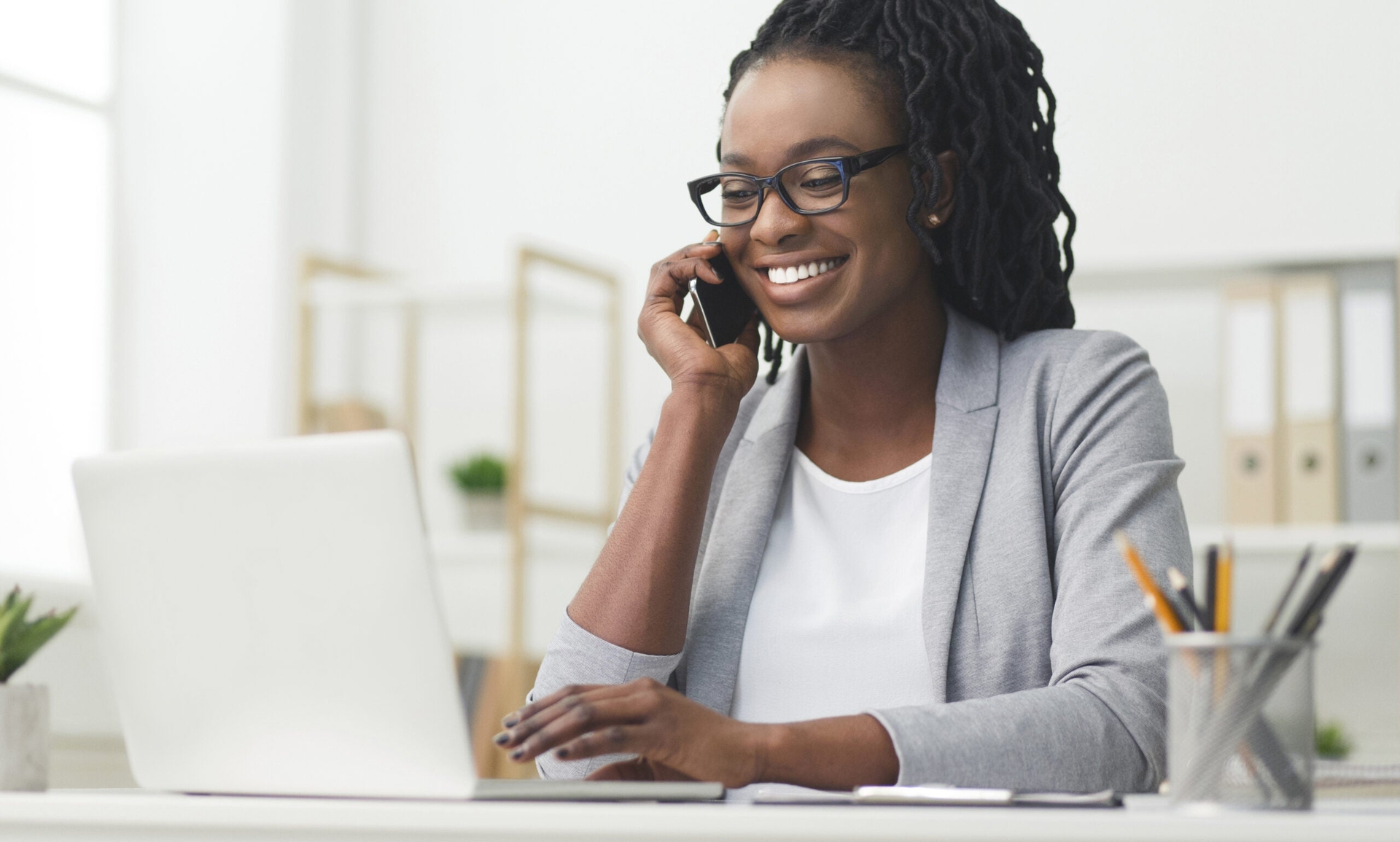 Woman on phone and using computer|