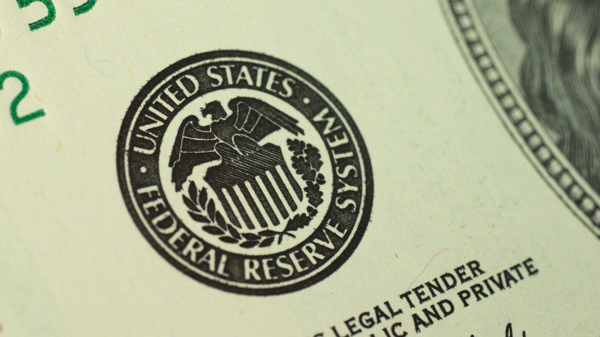 Close-up photo of the United States Federal Reserve System logo printed on a dollar bill