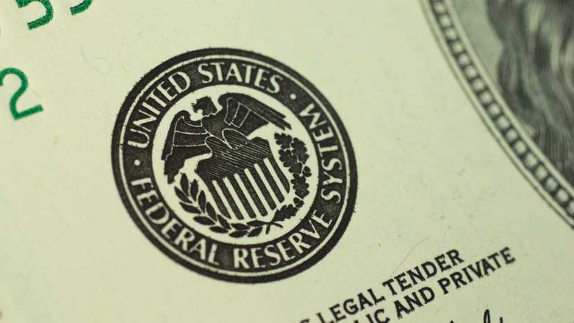 Close-up photo of the United States Federal Reserve System logo printed on a dollar bill
