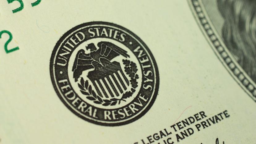 Close-up photo of the United States Federal Reserve System logo printed on a dollar bill