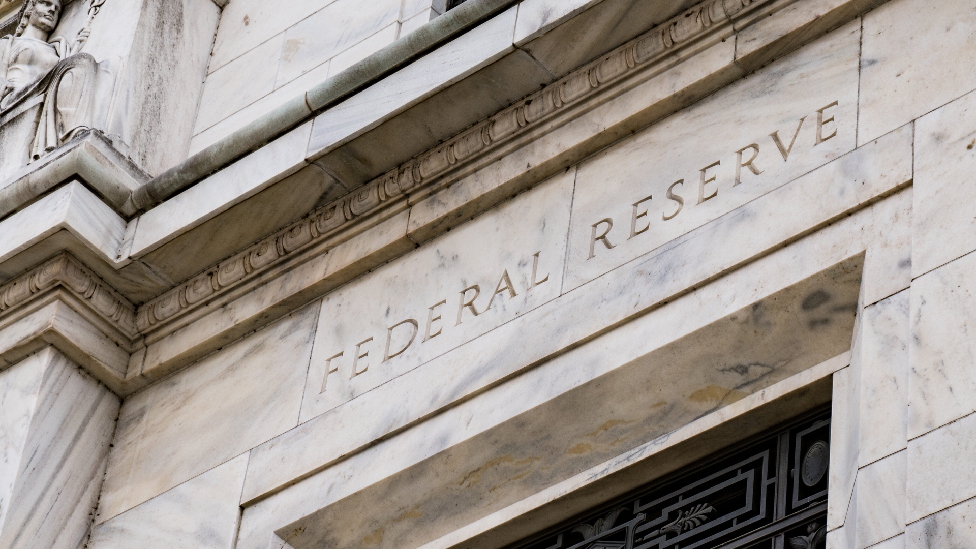 The exterior of the Federal Reserve building in Washington, DC with the words "Federal Reserve" visible.