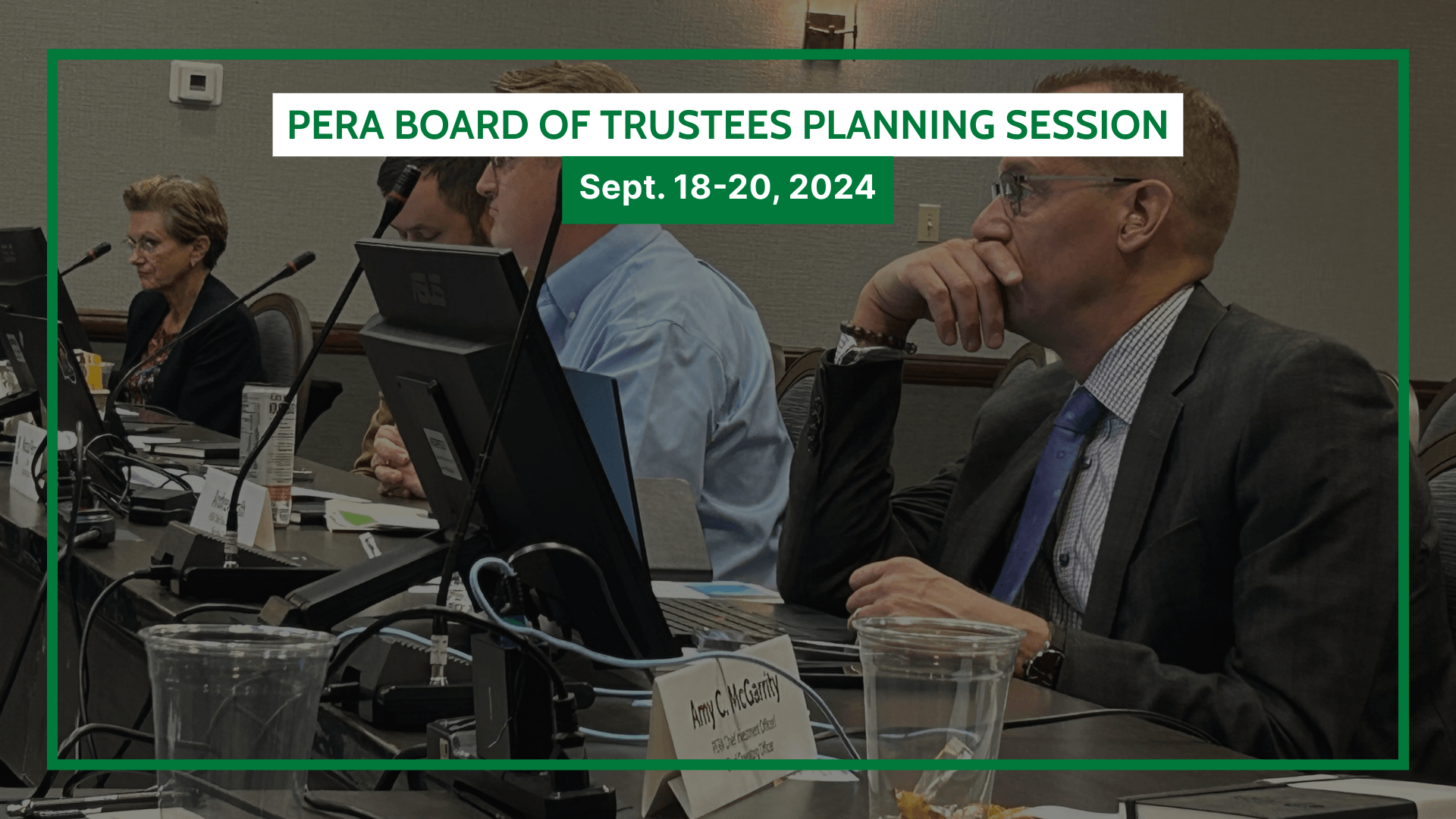 Several individuals are seated at a conference table with laptops and papers during the PERA Board of Trustees Planning Session, held from September 18-20, 2024.